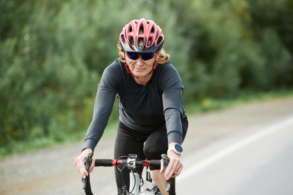 Woman road cycling through the mountains of Montenegro on a self-guided cycling tour