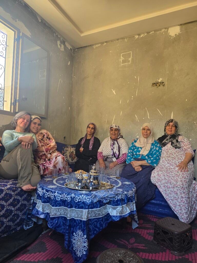 Women sharing tea inside a traditional Amazigh home in Morocco's High Atlas Mountains.